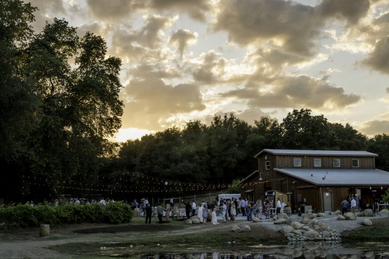 An outdoor wedding reception at a barn.