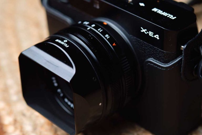 A small black lens and camera combo.