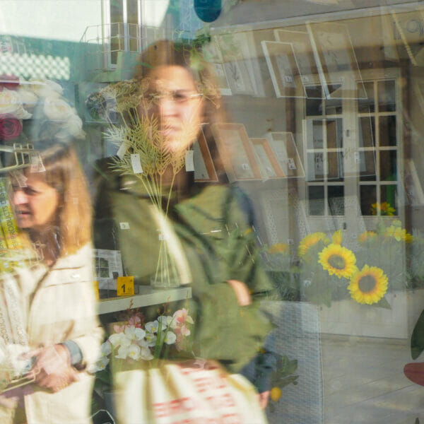 Reflections of women in a window.