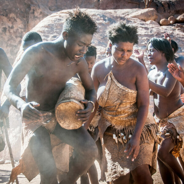 Africans doing a traditional dance and playing instruments.